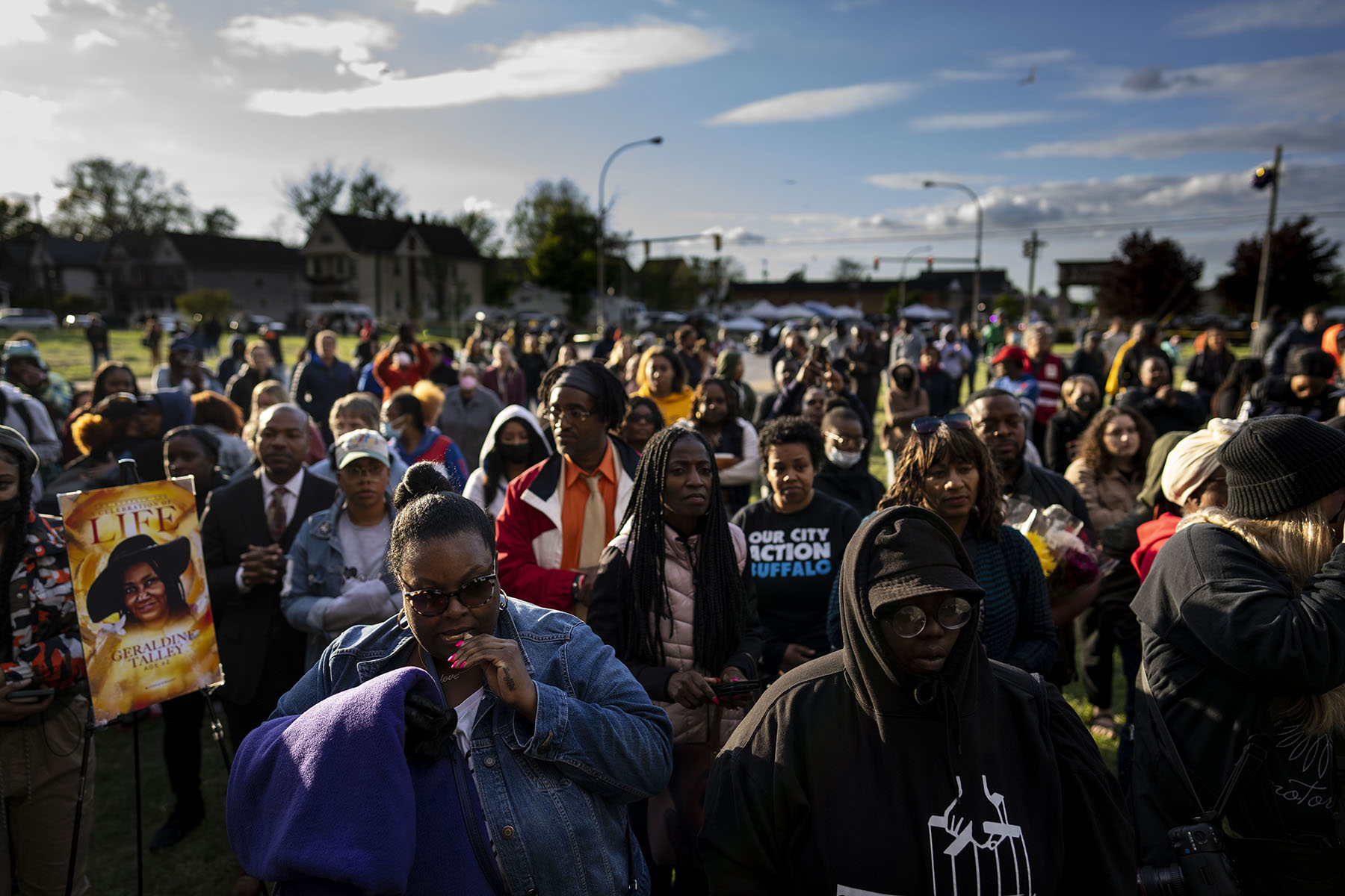 People attend a vigil across the street from Tops Friendly Market in May 2022.