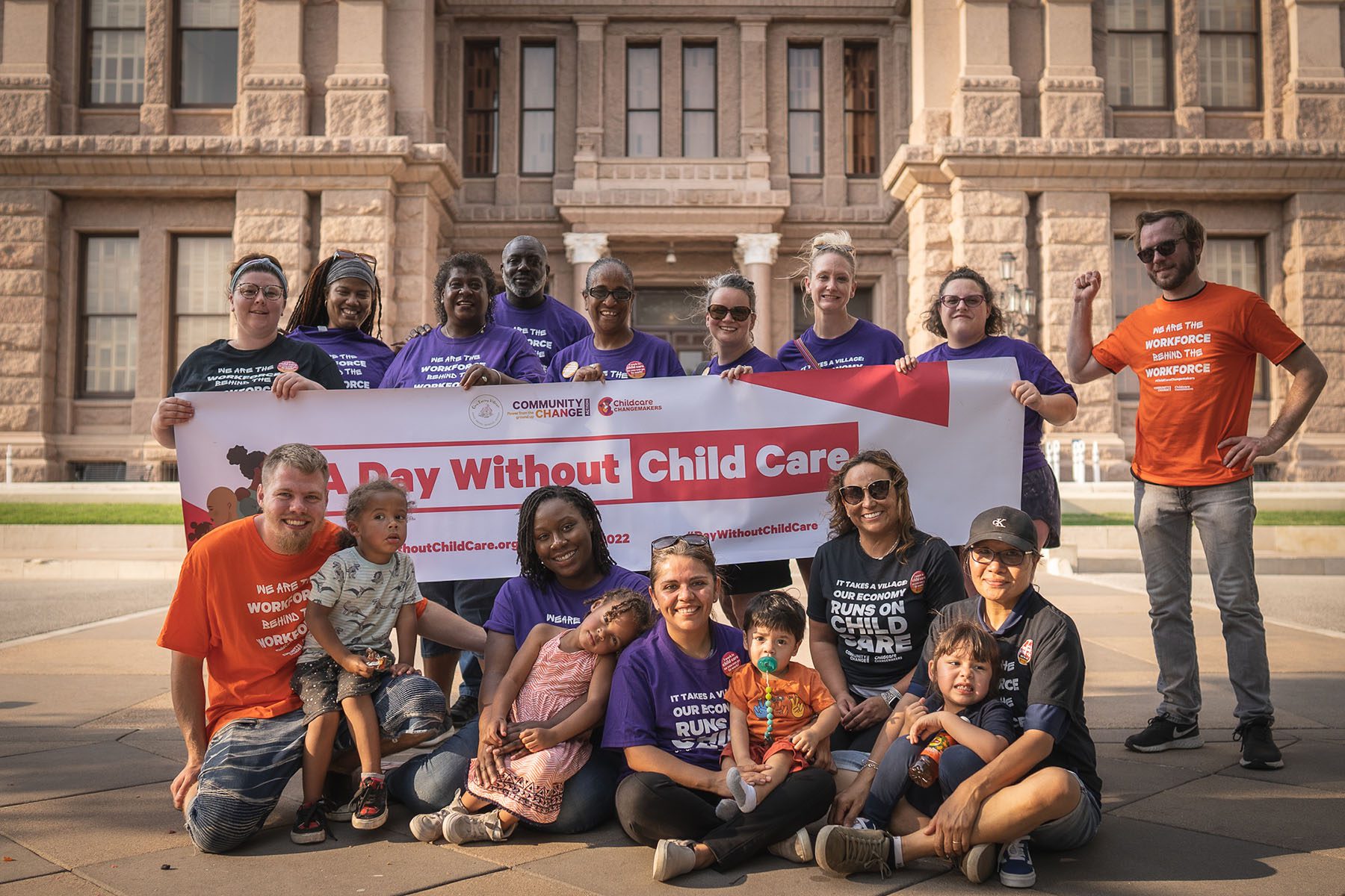 BriTanya Brown and other community activists hold a banner that reads "A Day Without Child Care."