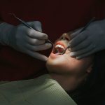 close up of a female patient with open mouth during a dental check up.