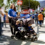 Hollie Overton, member of the Writers Guild of America, poses with her children while on strike near The Walt Disney Studios.