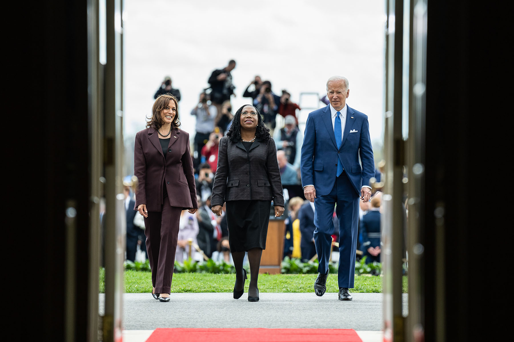 President Joe Biden and Vice President Kamala Harris return to the White House with Supreme Court Justice Ketanji Brown Jackson following an event on the South Lawn to commemorate her confirmation.