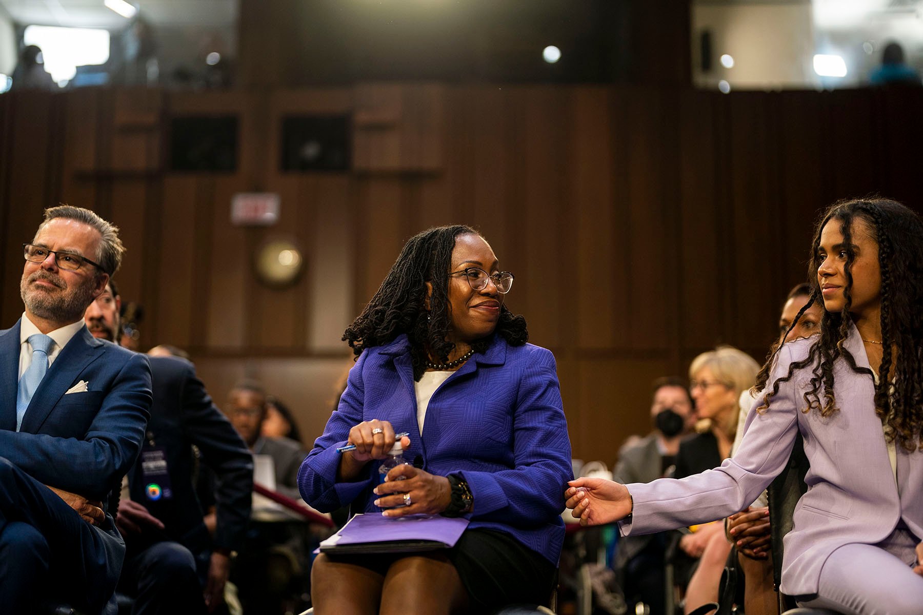 Supreme Court nominee Judge Ketanji Brown Jackson turns to her daughter Leila Jackson, who reached out to touch her arm as Judge Jackson joins her family in the audience area during her Senate Judiciary Committee confirmation hearing.