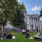 People participate in a sit-in at the Colorado State Capitol organized by Here 4 The Kids, a group founded by women of color that opposes gun violence and white supremacy,