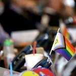 A small pride flag decorates a desk on the Democratic side of the Kansas House of Representatives in Topeka, Kansas.