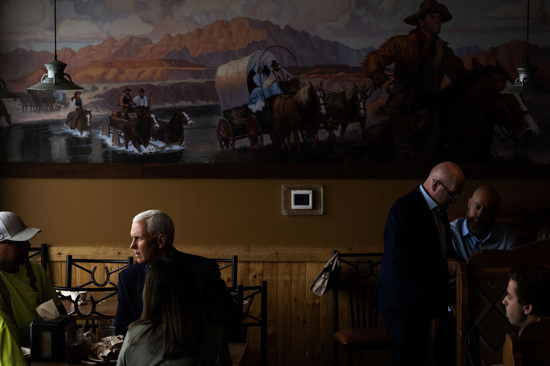 Mike Pence speaks to diners during a campaign event at a restaurant in Waukee, Iowa, June 2023.