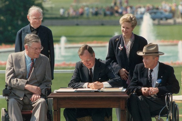 George Bush signs the Americans with Disabilities Act in Washington D.C., in July 1990.