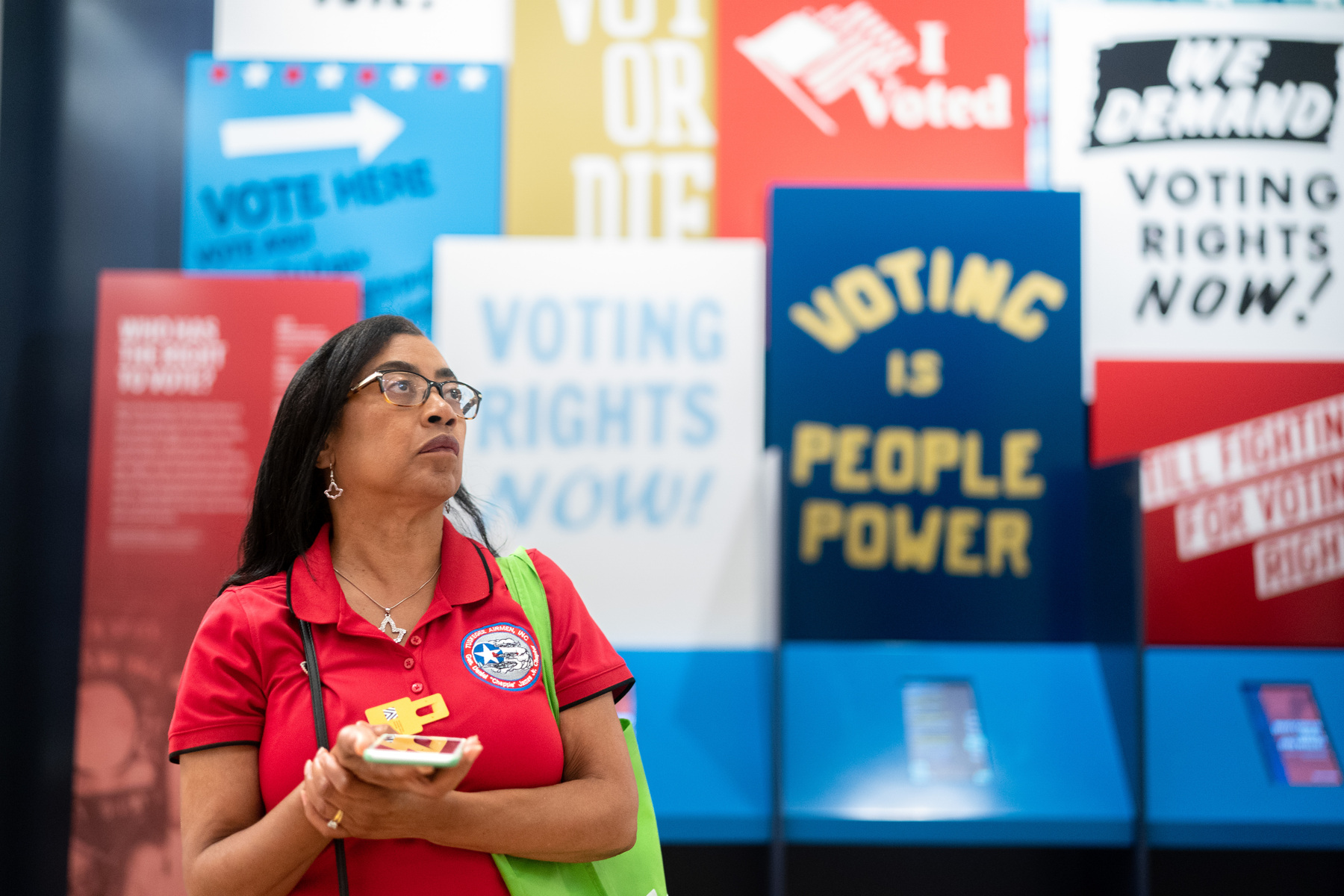A woman walks through an exhibit on voting rights at the International African American Museum.