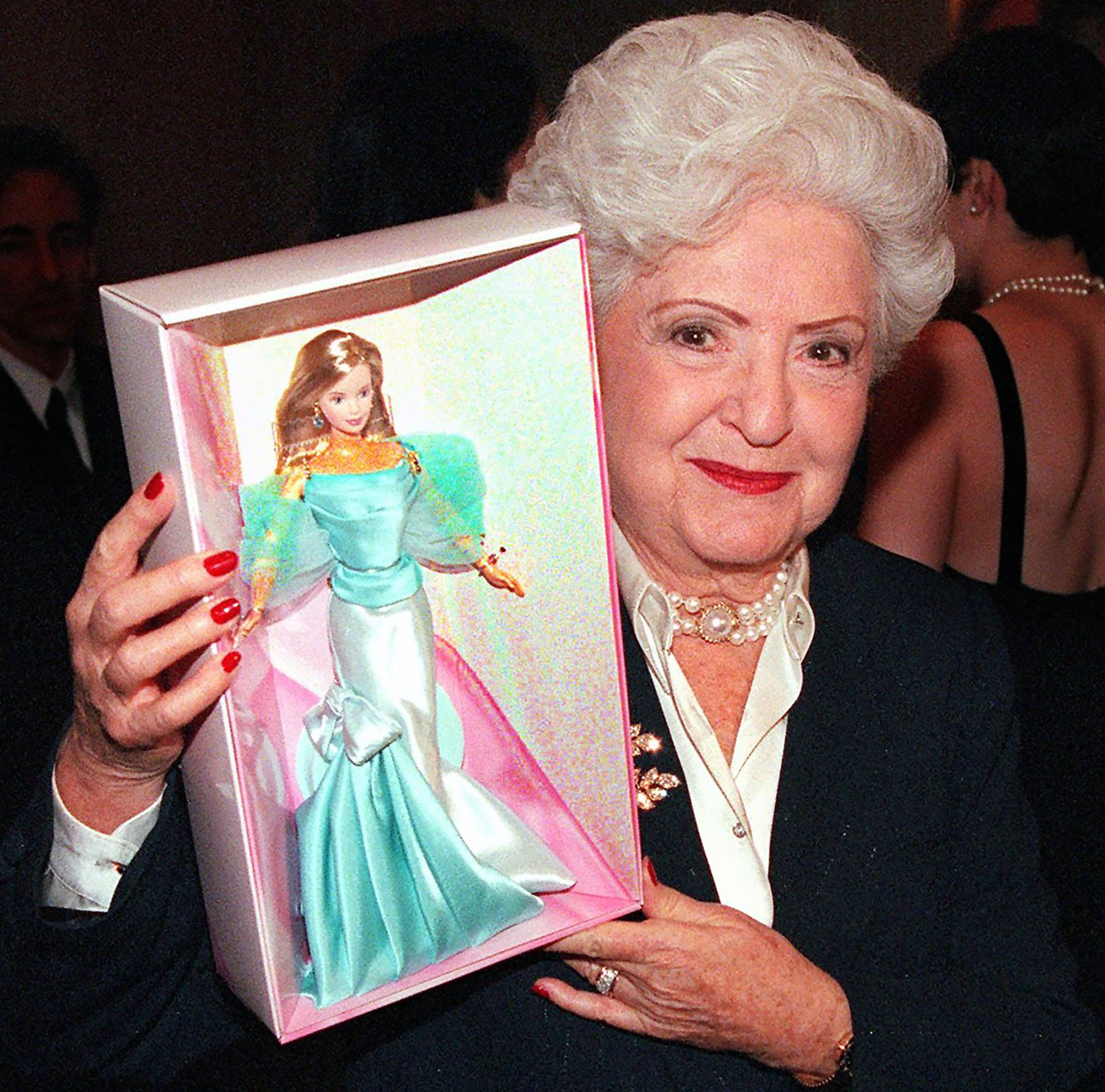 Ruth Handler poses for a picture with a special edition Barbie in hand.