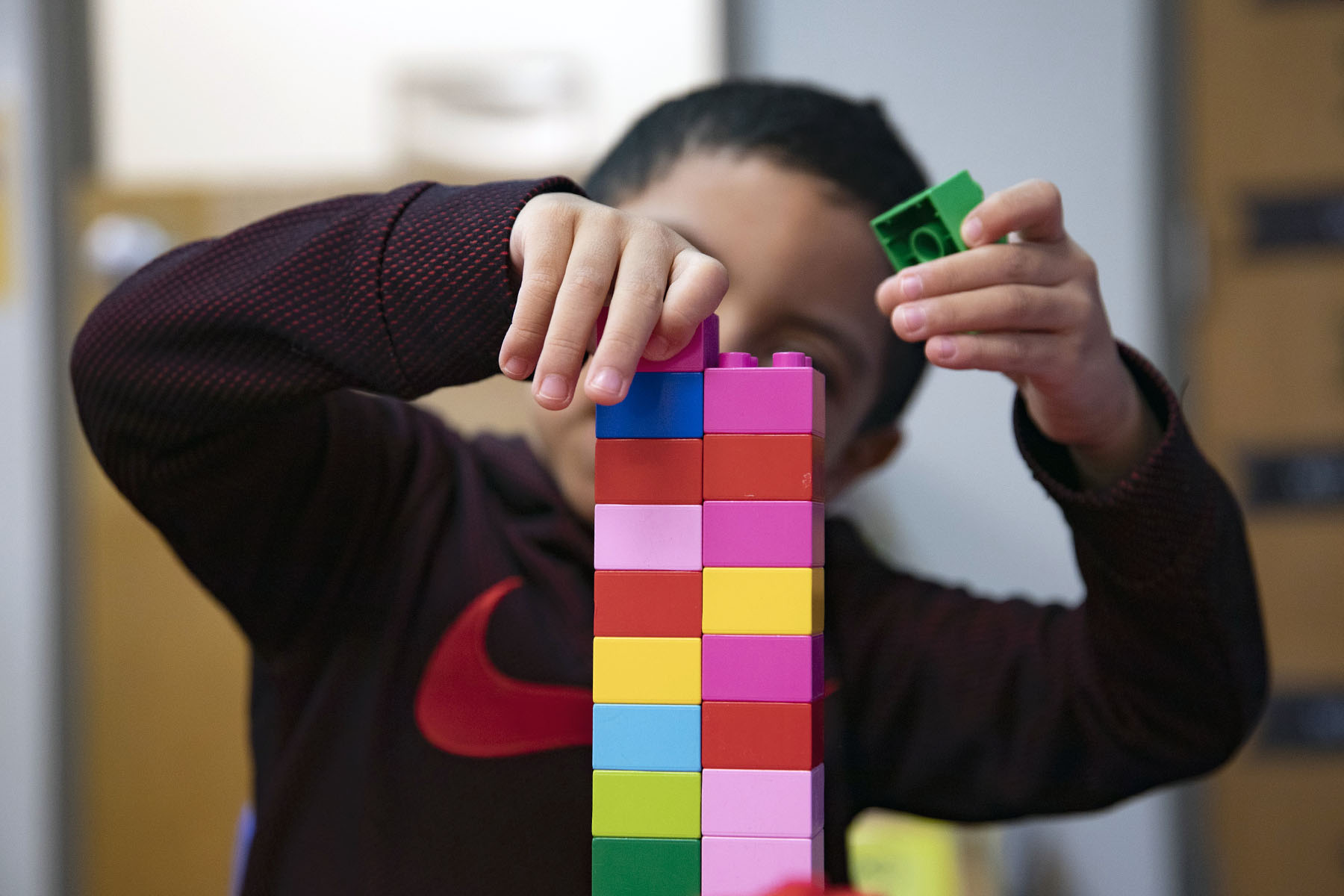 A child plays with a lego set at a daycare.