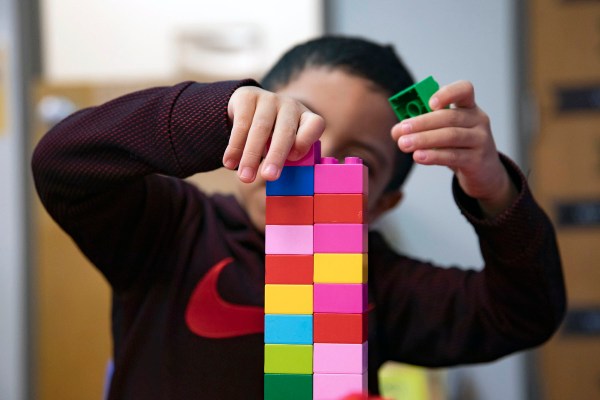 A child plays with a lego set at a daycare.