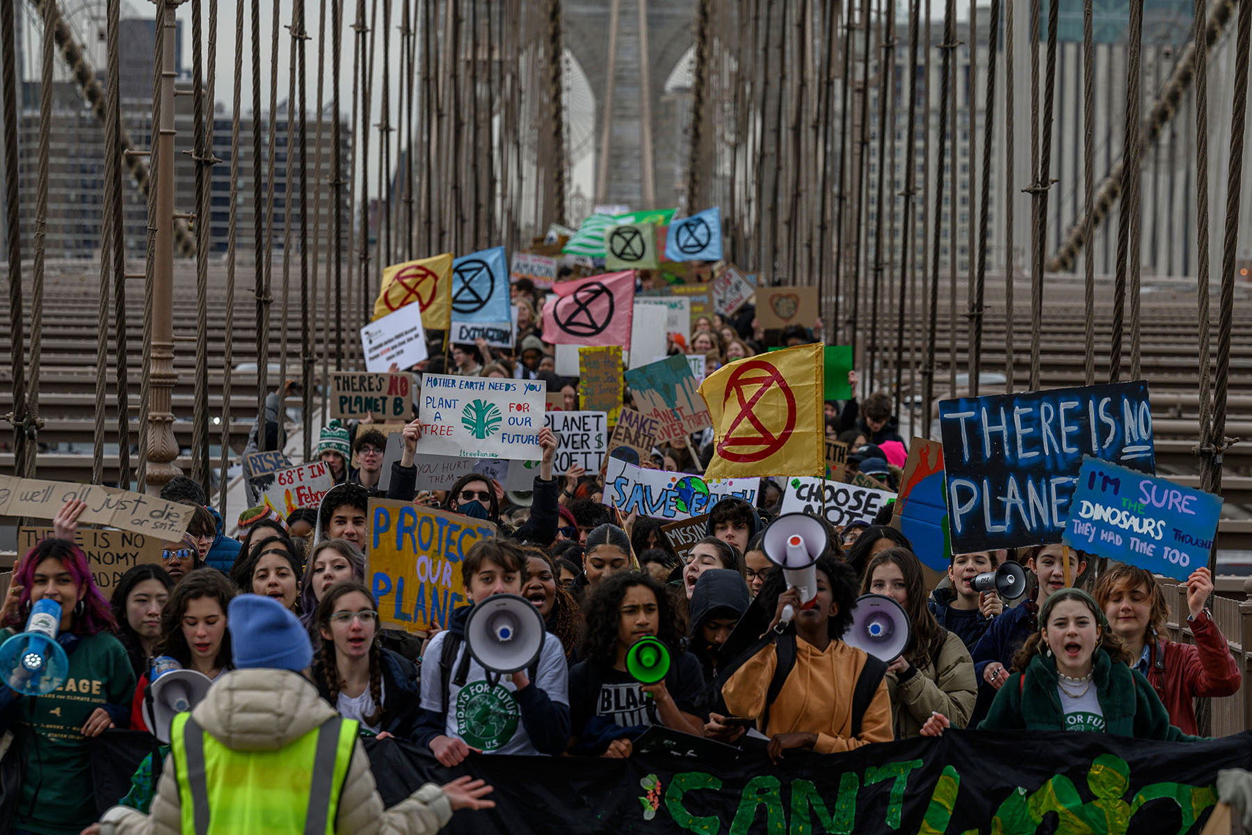 Activists shout slogans and march during a Global Climate Strike in March 2023 in New York City.