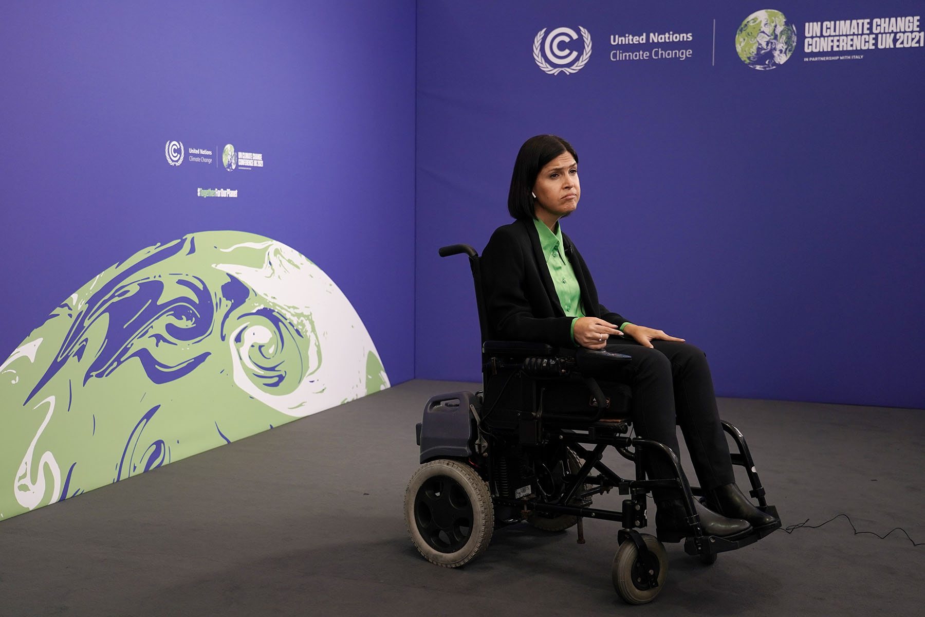 Israel's Energy Minister Karine Elharrar sits on the sidelines in her wheelchair at COP26.