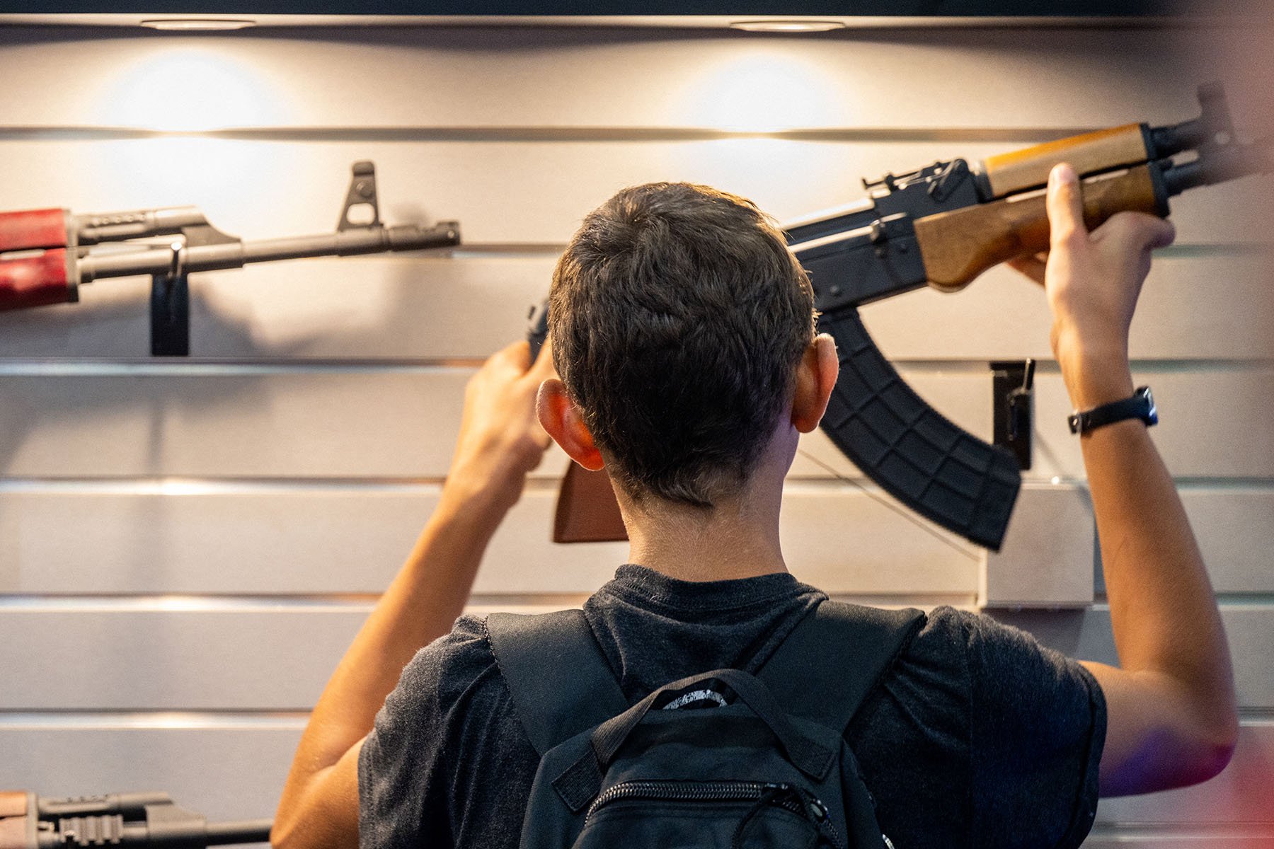 A boy examines a firearm during the National Rifle Association's annual convention.