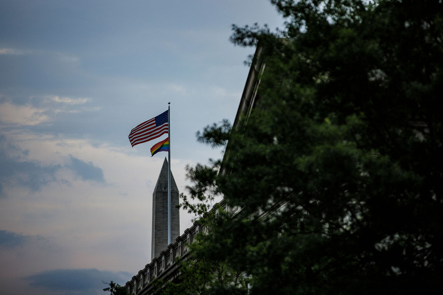 A Pride flag flies with the U.S. flag above the Treasury Department in Washington, D.C.