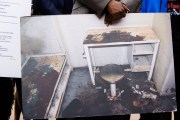 Attorney Michael Harper holds a photo of Lashawn Thompson's cell at the Fulton County Jail at a news conference. The cell is filthy, and filled with dirt and garbage. The furniture is rusted over and in terrible condition.