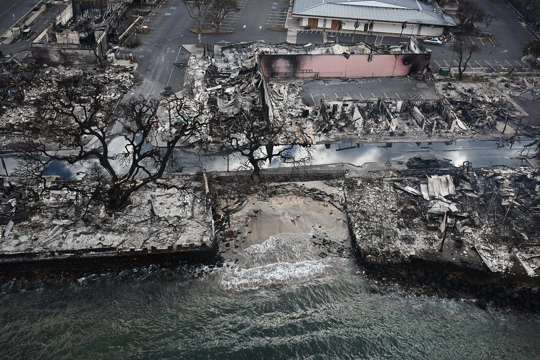 Homes and building are burned to the ground on the waterfront in Lahaina in the aftermath of wildfires.