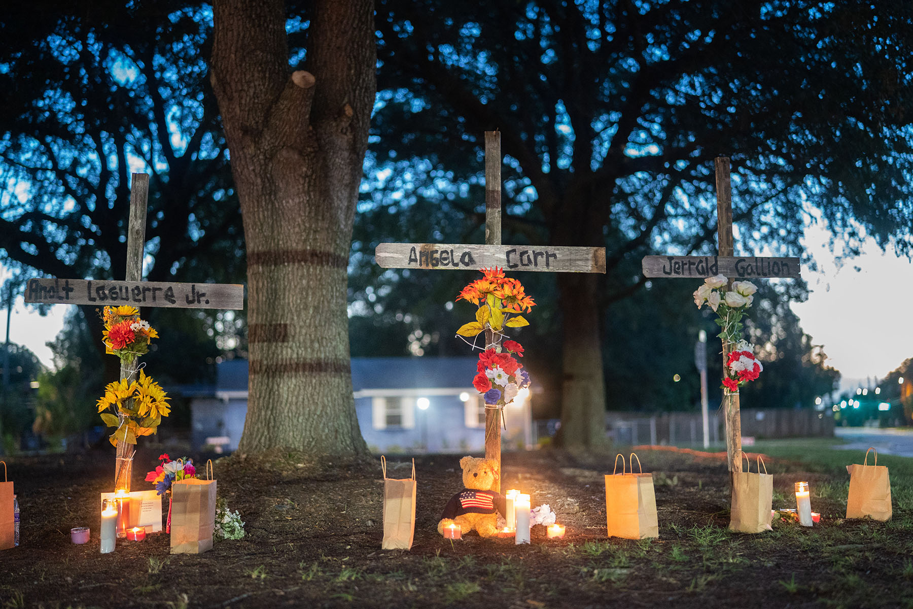 Candles burn at memorials for Angela Carr, Anolt Joseph Laguerre Jr. and Jerrald Gallion near the Dollar General store where they were shot and killed.