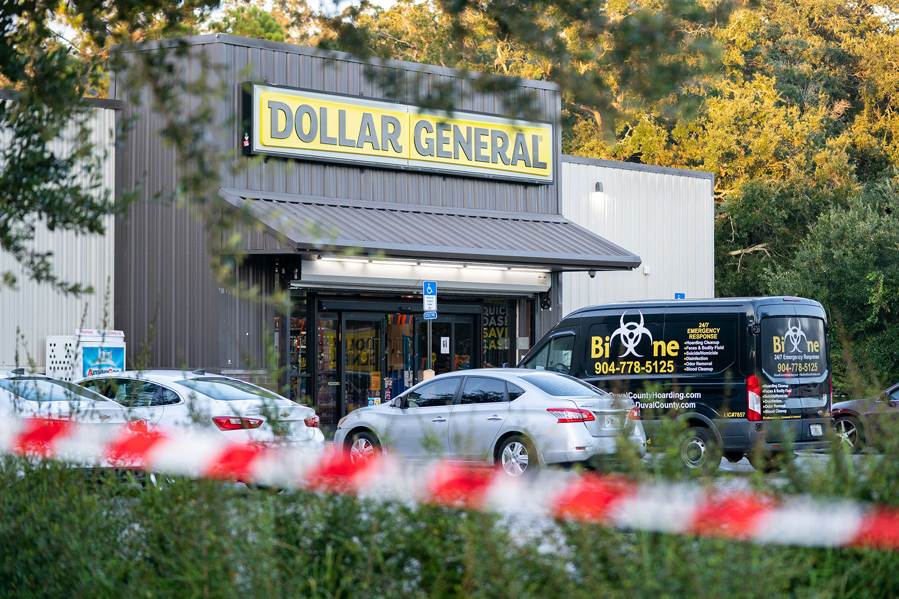 A biohazard cleanup vehicle is parked outside the Dollar General store where three people were shot and killed.