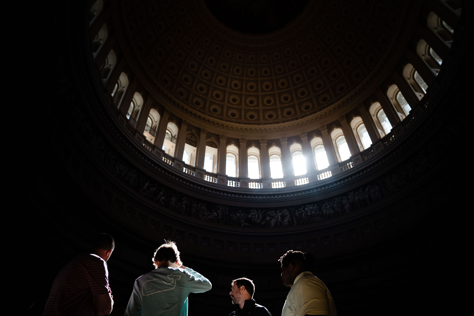Tour groups walk through the rotunda of the Capitol.