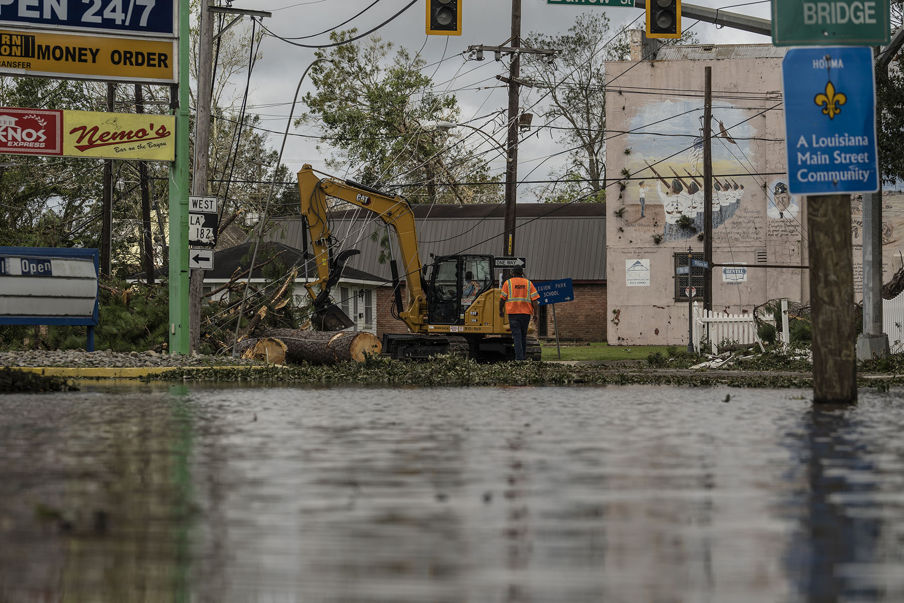 Workers clears debris on the street in Houma, Louisiana.