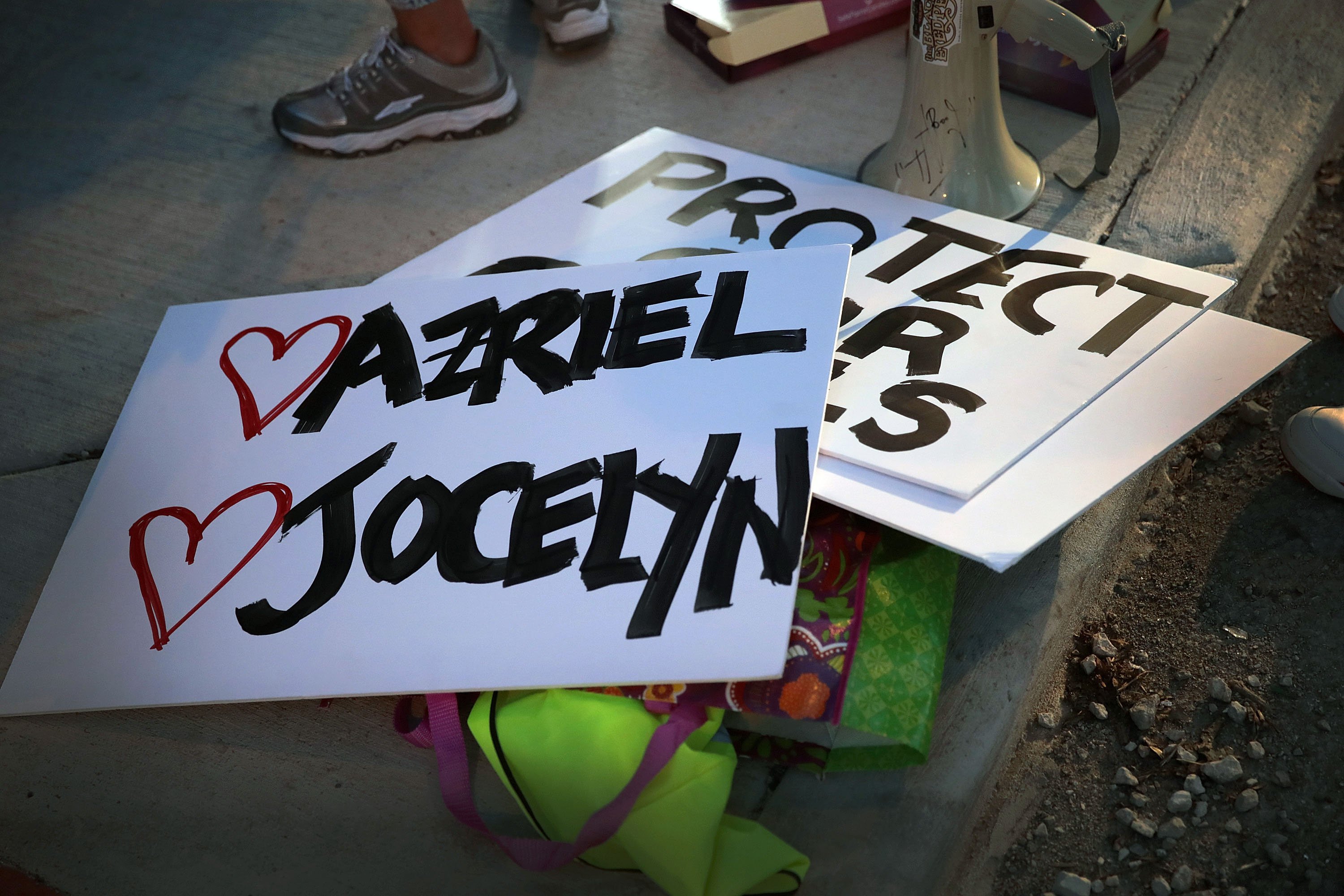 Signs bearing the names of survivors of singer R. Kelly lay on the ground before the start of a demonstration near his studio in Chicago, Illinois.