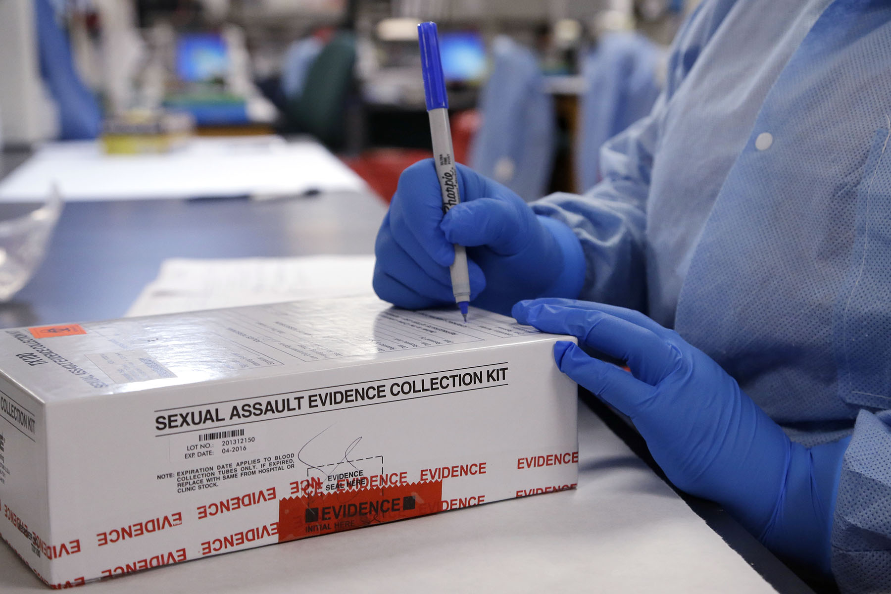 A sexual assault evidence collection kit is checked in by a forensic analyst for testing.