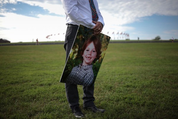 Mark Barden holds a picture of his son on the national mall during a call for action on preventing gun violence.