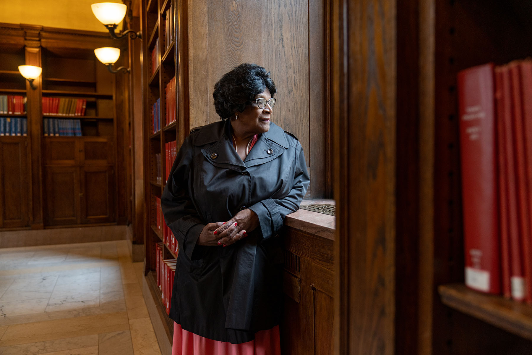 Althea Garrison looks out a window at the Boston Public Library.