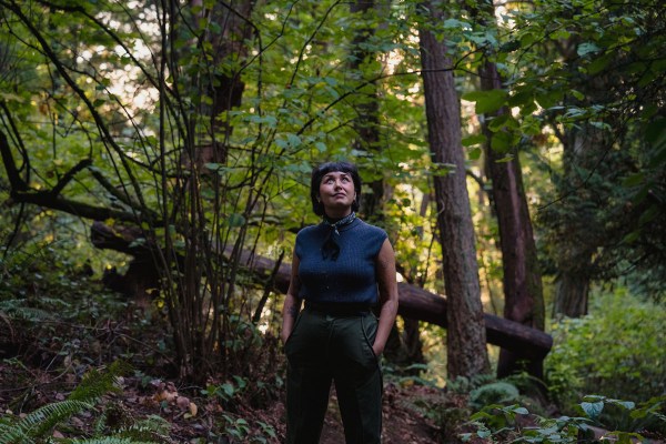 Michelle Barboza “MB” Ramirez, Latinx naturalist and co-host of Eons on PBS, poses for a portrait amongst the trees at Seward Park in Seattle, Washington.