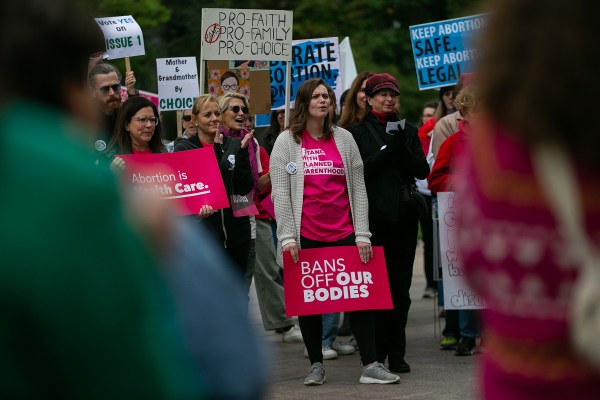 People attend a rally hosted hosted by Ohioans United for Reproductive Rights outside of the Ohio Statehouse.