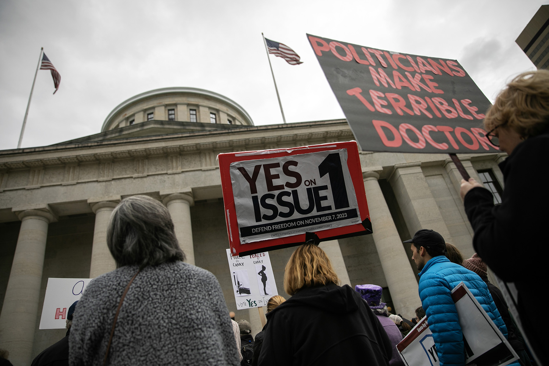 People attend a rally hosted by Ohioans United for Reproductive Rights outside of the Ohio Statehouse.