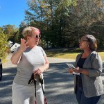 Democratic Virginia House candidate Kim Pope Adams speaks to a voter outside.