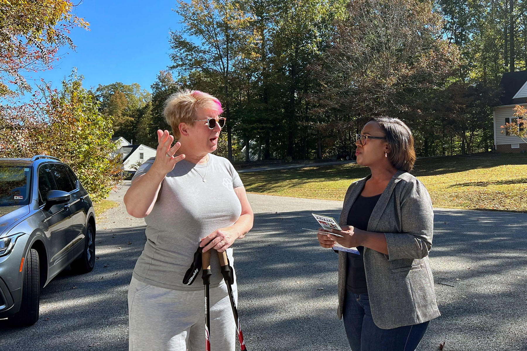 Democratic Virginia House candidate Kim Pope Adams speaks to a voter outside.