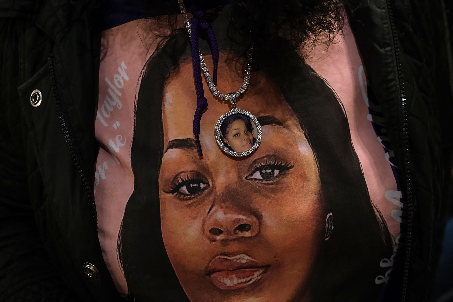 Bianca Austin wears a sweater and necklace with a photo of her niece Breonna Taylor.