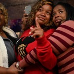 Breonna Taylor's mother, Tamika Palmer, cries as she stands with her friend Tooshy Hamilton (left) and sister Stephanie Baskin during an unveiling of a Breonna Taylor painting.