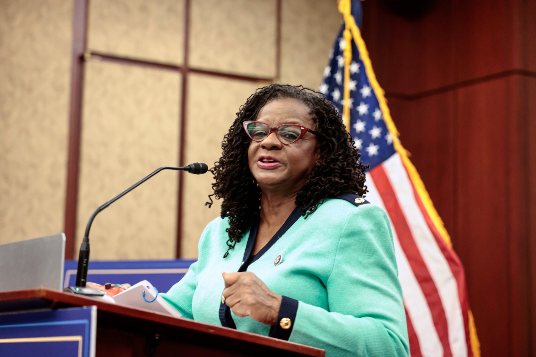 Rep. Gwen Moore, Democrat of Wisconsin, wearing a green suit and red glasses