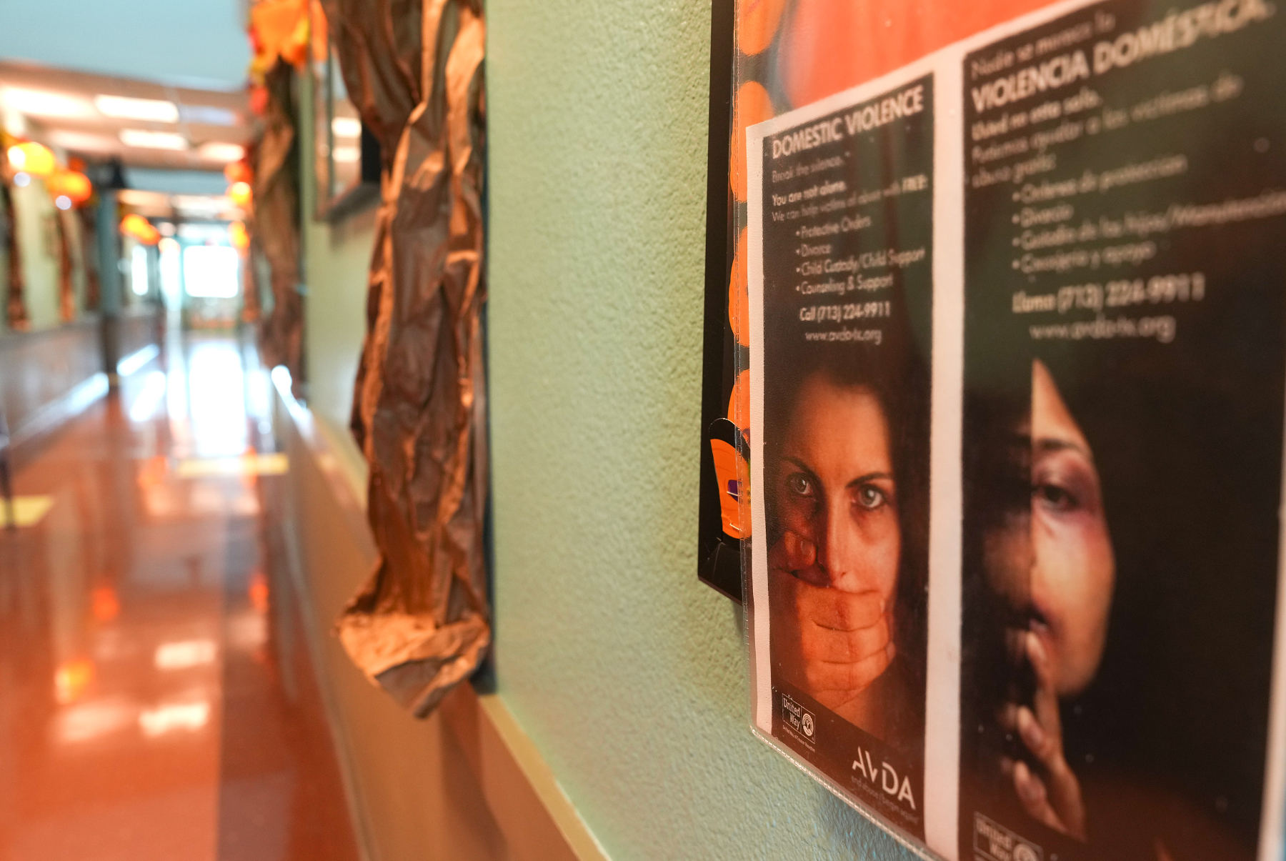 Posters about domestic violence in a hallway at a campus in Houston