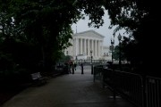 A view of the United States Supreme Court from a tree-lined walkway