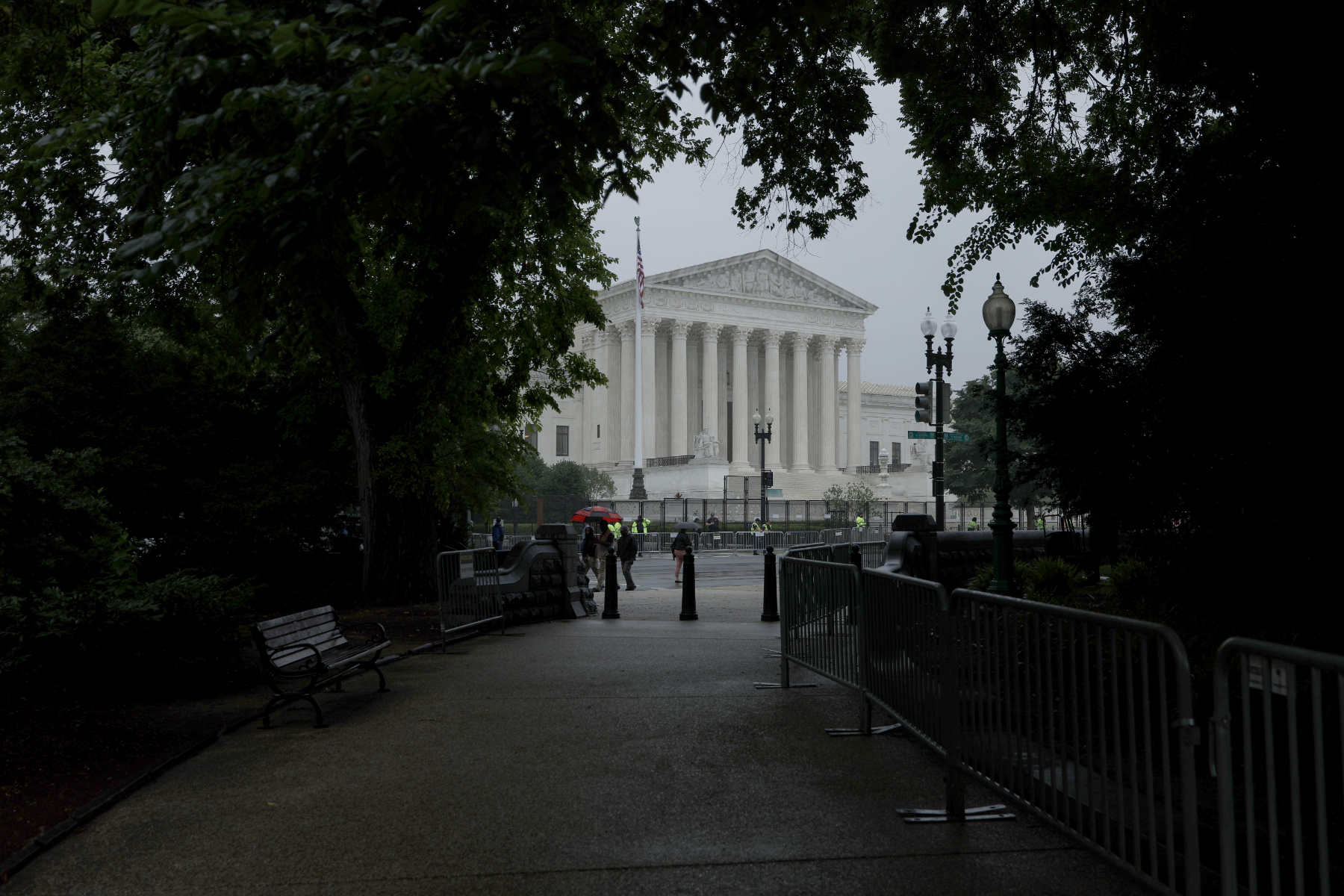 A view of the United States Supreme Court from a tree-lined walkway