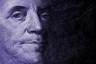 Close up of Benjamin Franklin's face on a hundred dollar bill.