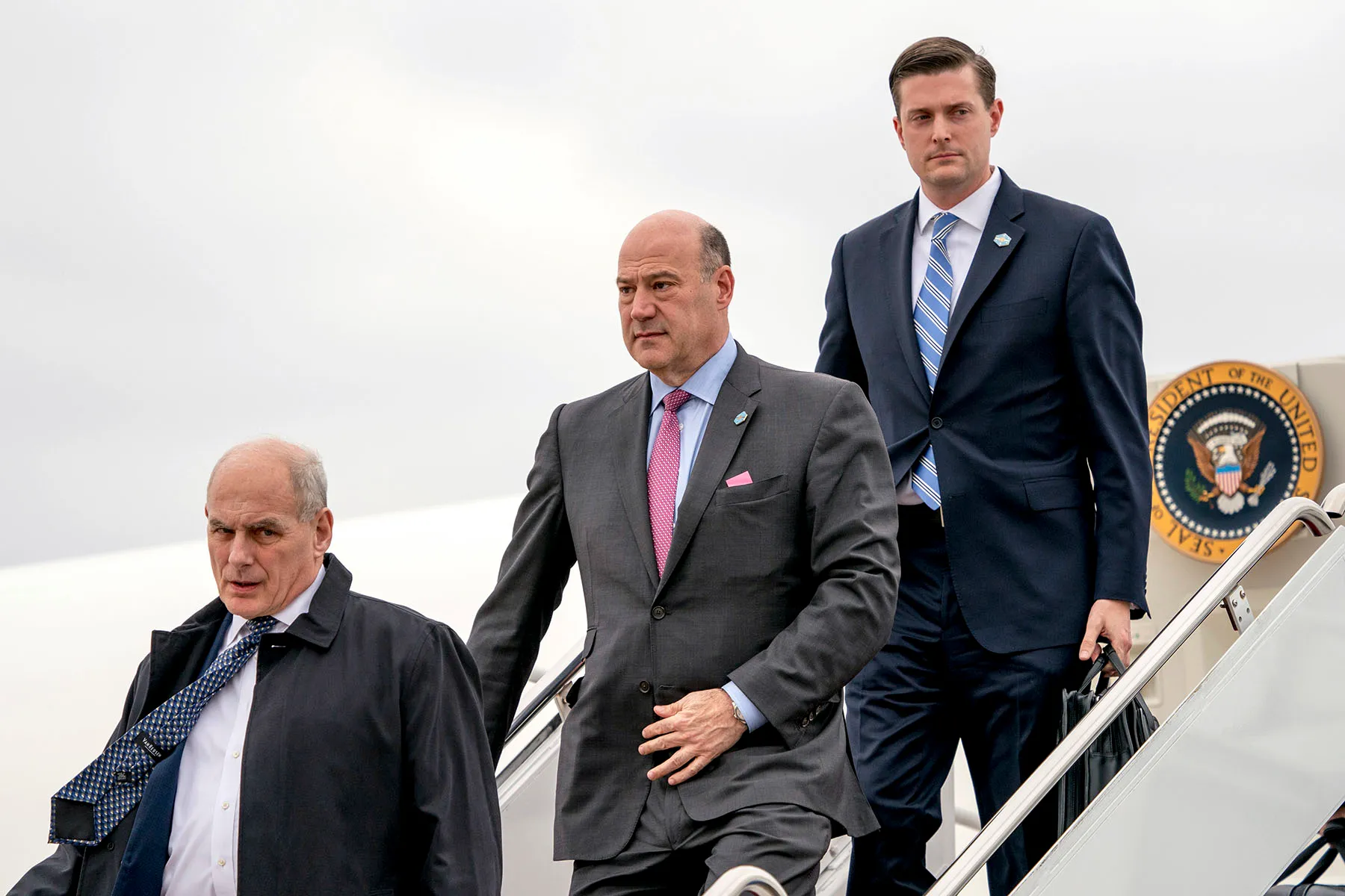 John Kelly (left), Gary Cohn (center) and Rob Porter arrive at Andrews Air Force Base in Maryland.