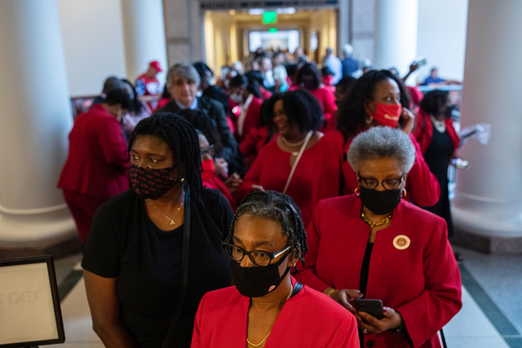 Women dressed in red line up to testify before the TexasHouse Select Committee on Constitutional Rights and Remedies, which began hearings on bail reform and election integrity bills.