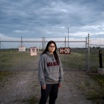 Ella Weber stands in front of a nuclear silo on Fort Berthold Reservation.