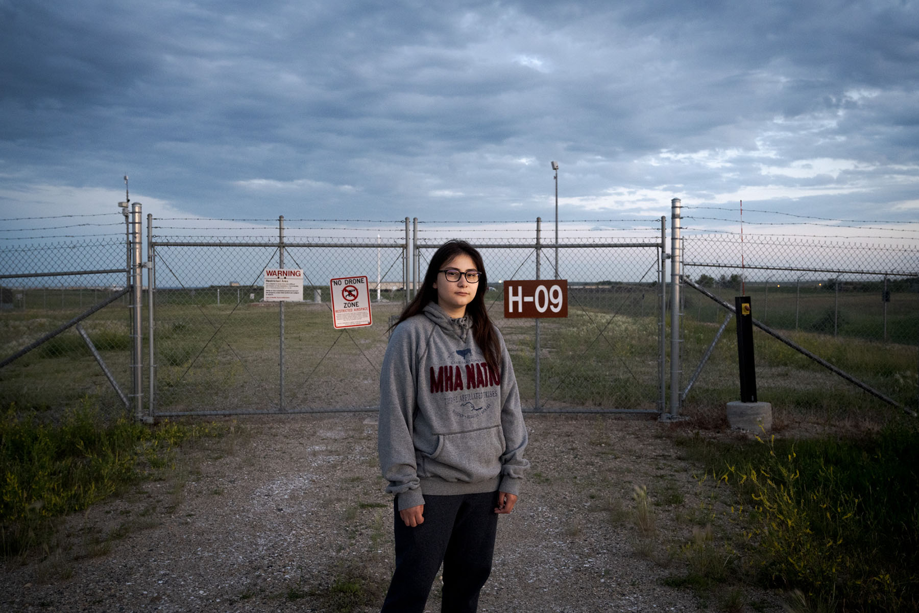 Ella Weber stands in front of a nuclear silo on Fort Berthold Reservation.