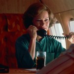 First Lady Rosalynn Carter talks on the telephone in a plane as she returns home from a campaign trip to Florida.