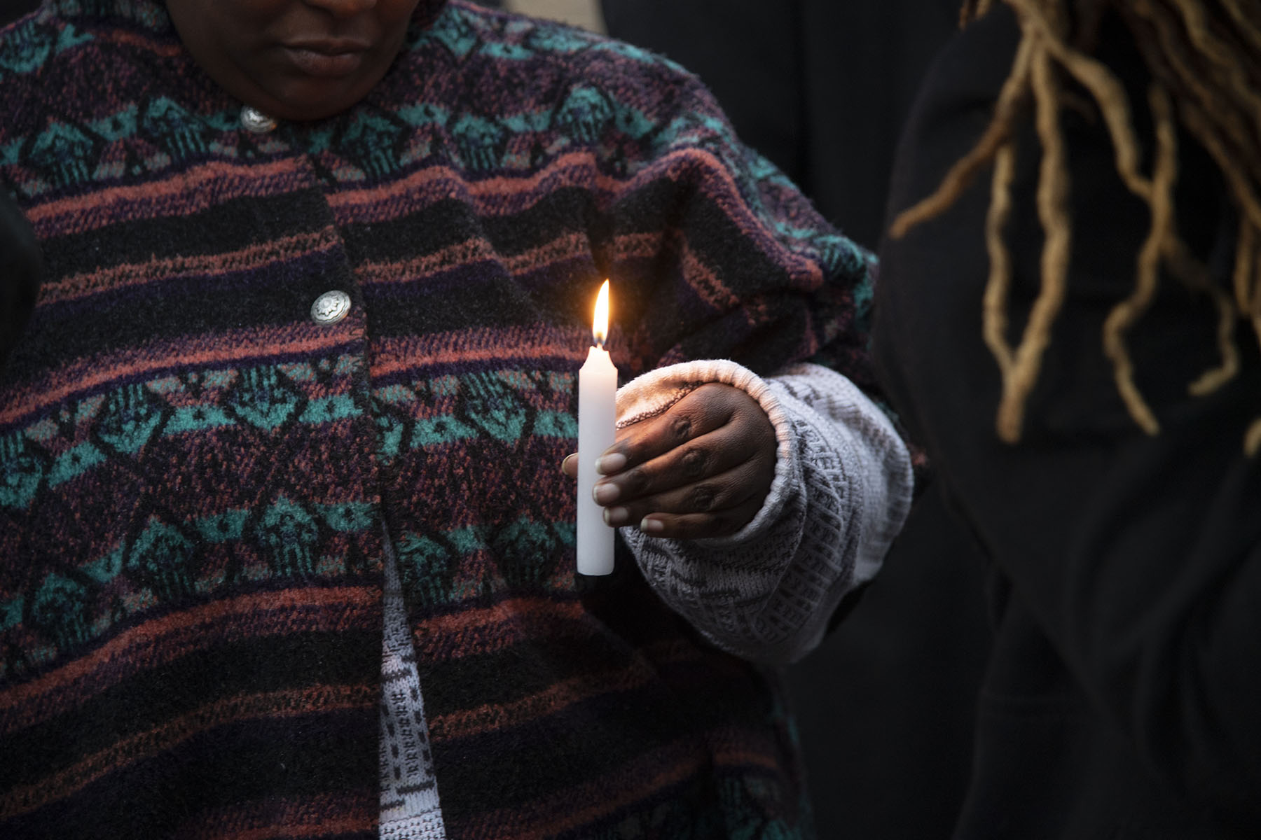 The transgender community gathers to mourn the death of Ashanti Carmon at a candelit vigil.