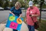 Protesters stand outside a Loudoun County Public Schools board meeting in Ashburn, Virginia in October 2021. One hold a signs that reads 