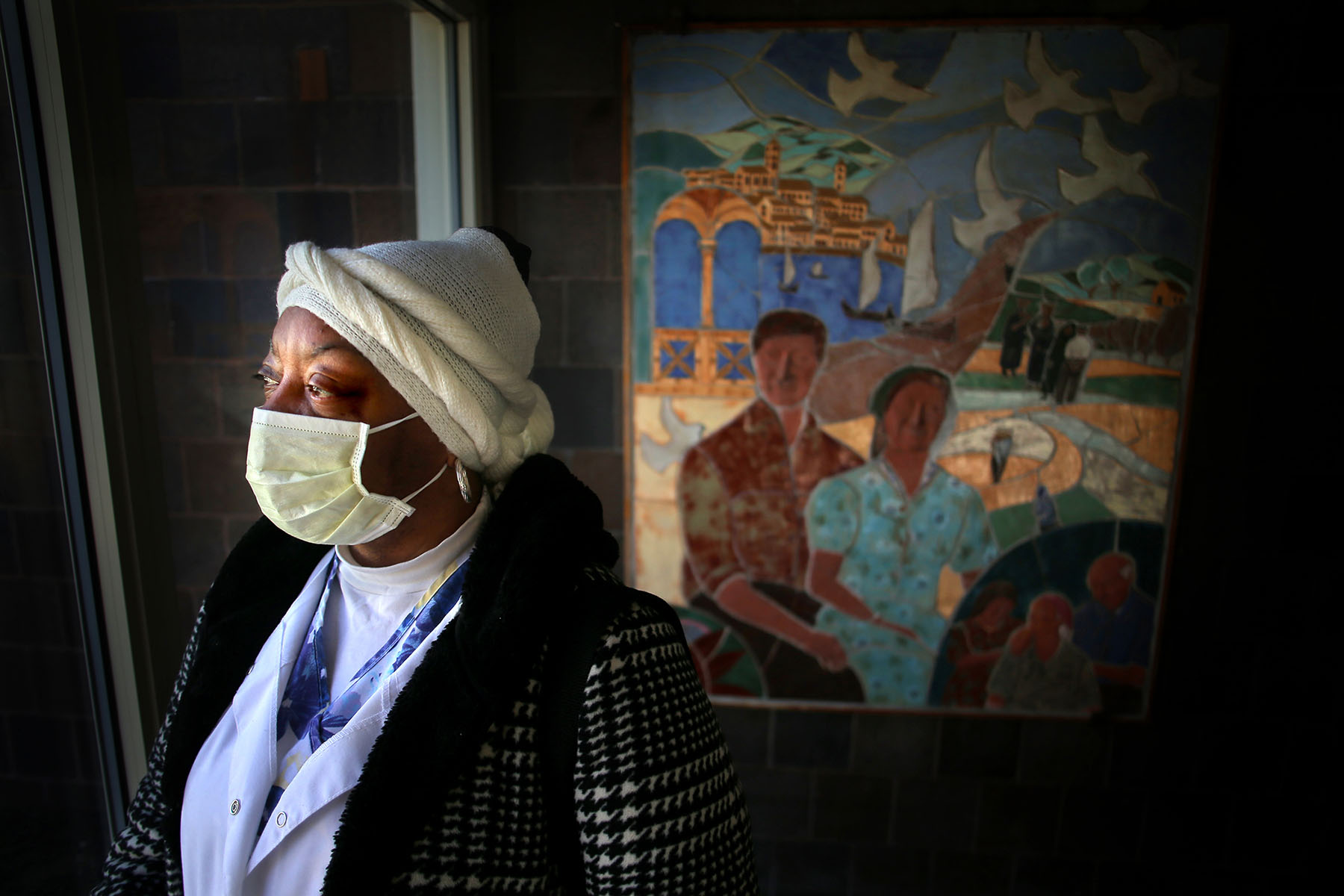 A personal care assistant wearing a face mask prepares to go to work.