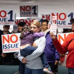 A woman is seen hugging a child as anti-abortion canvassers signs at Columbus Christian Center ahead of Election Day.