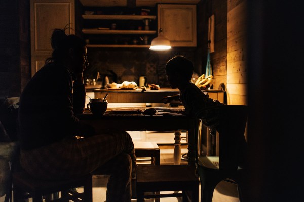 Photo of young mother spending time with her son at the kitchen table.